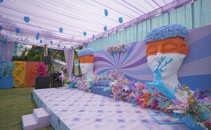 Lilac themed outdoor setup with a retro swirl backdrop and checkered flooring by RAW Group